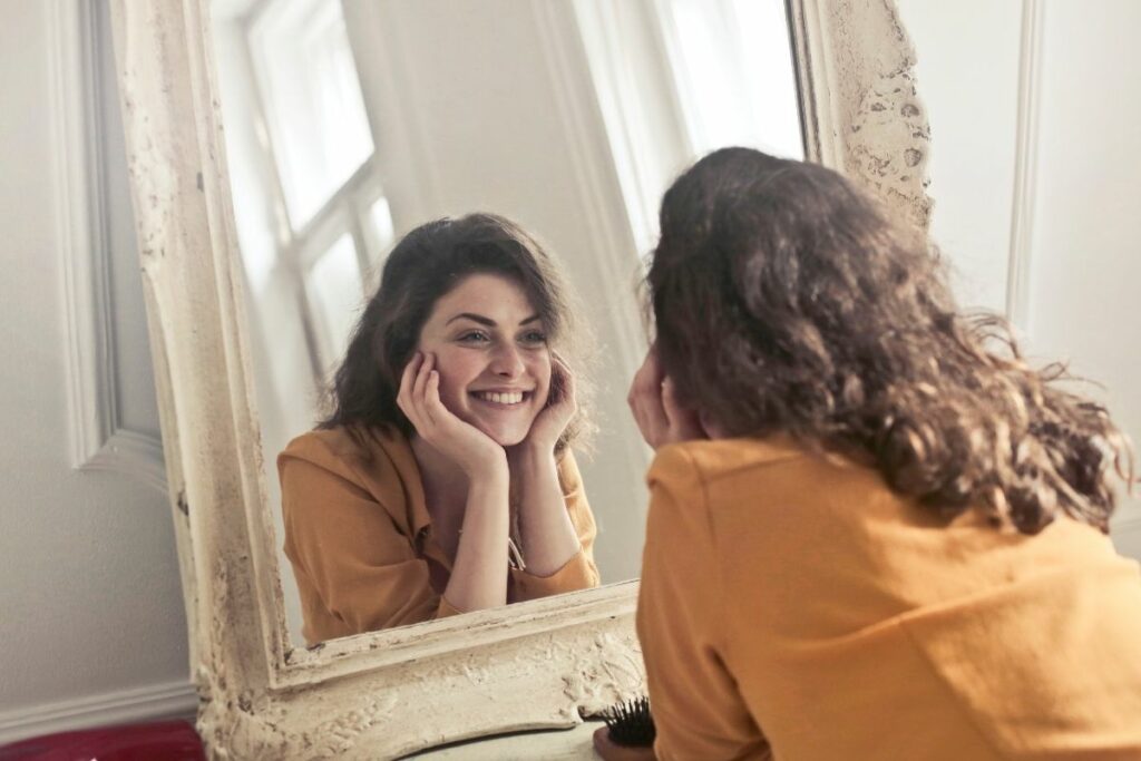 Happy Woman Looking in the Mirror