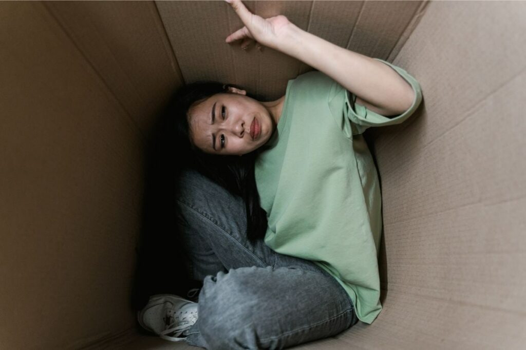 Woman Squeezed into a Cardboard Box